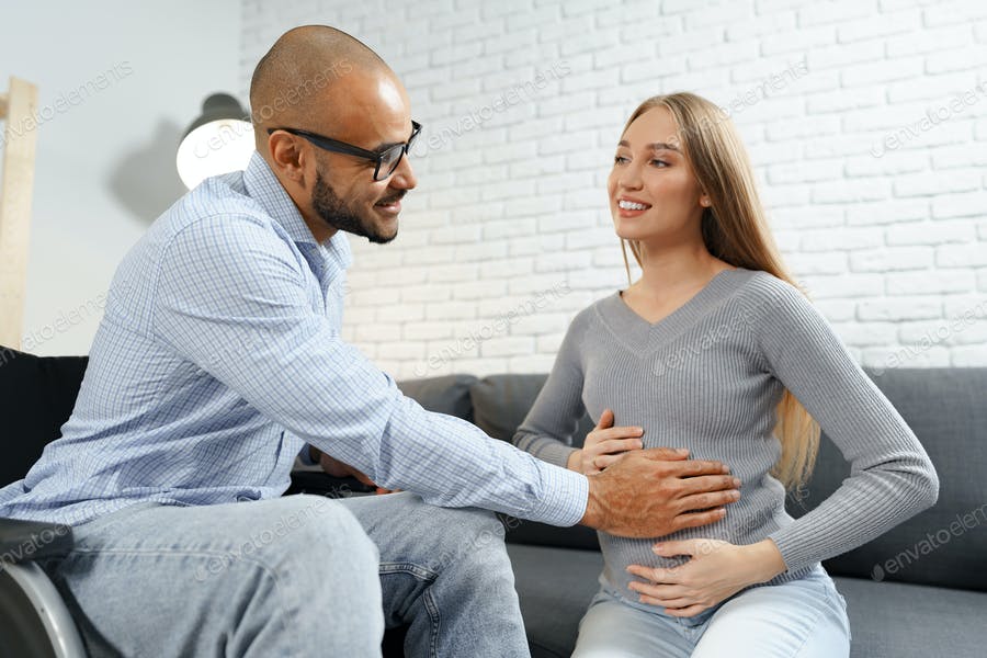 عکس مرد در حال لمس شکم حامله خانمش